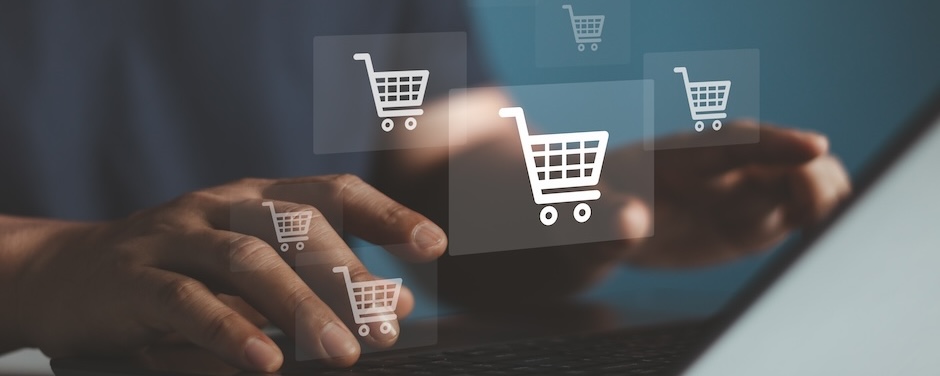 Hands typing with shopping cart icons surrounding the keyboard