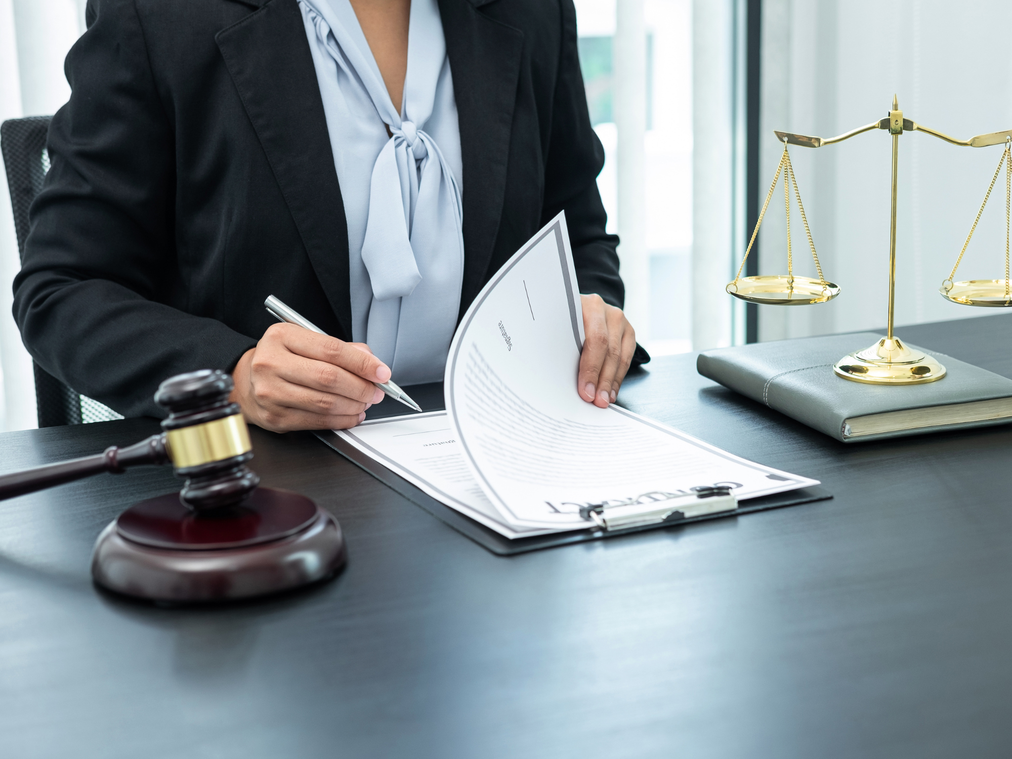 A lawyer reading papers on a desk