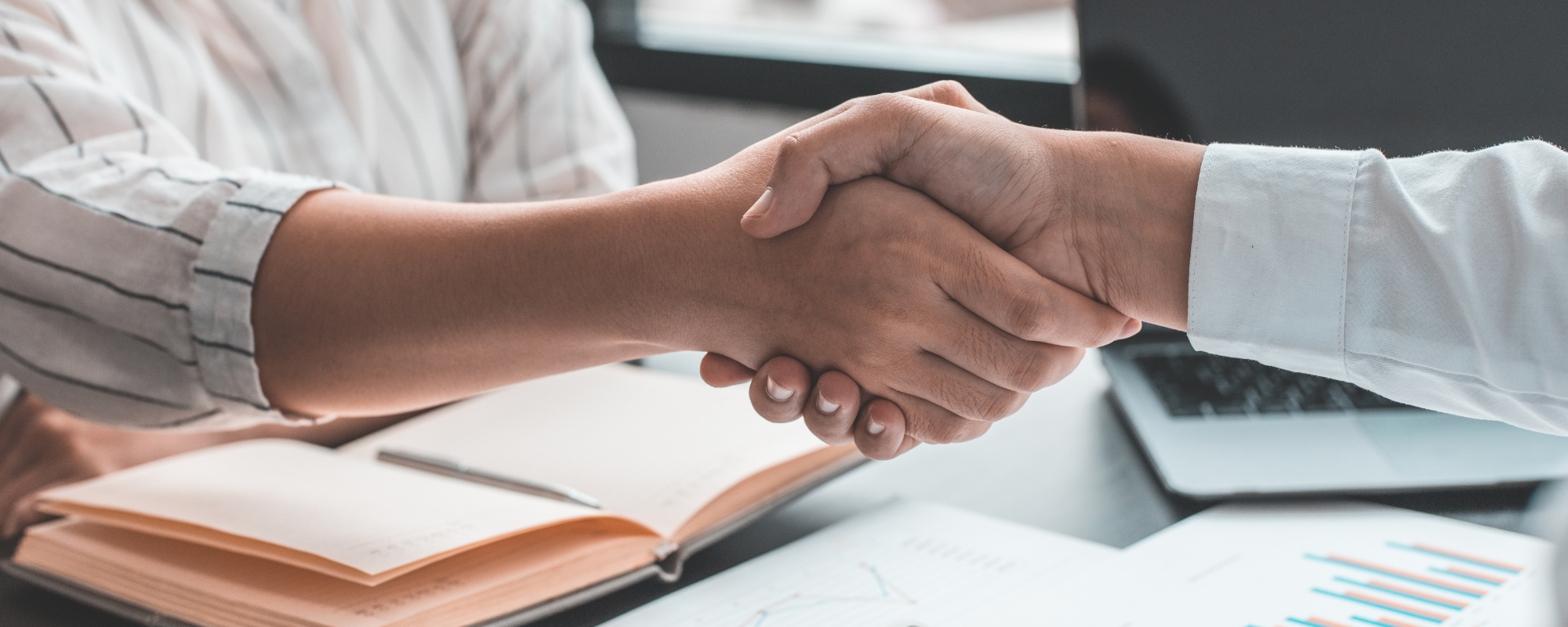 A handshake across a desk - Building Strong Relationships with Authorized Resellers: The Key to MAP Compliance and More