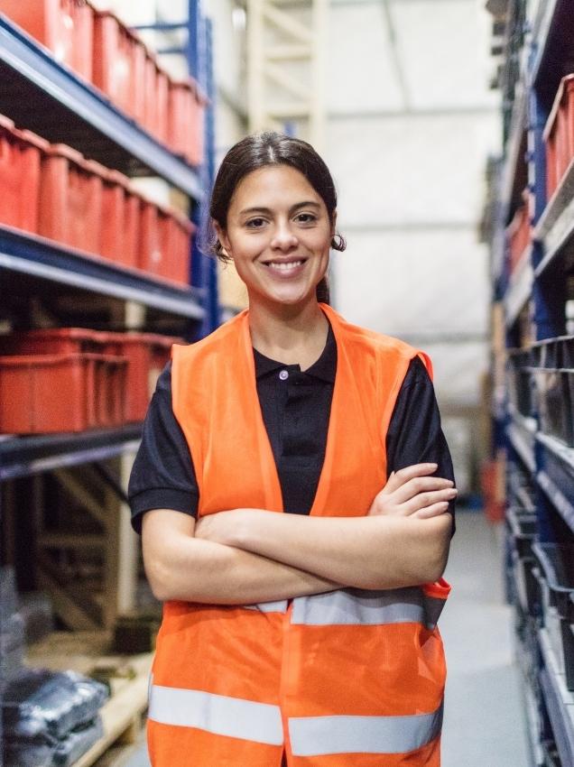 A warehouse/shipping manager standing in the warehouse in front of products - Why Internal Stakeholders Can Be the Difference When Enforcing MAP Policies