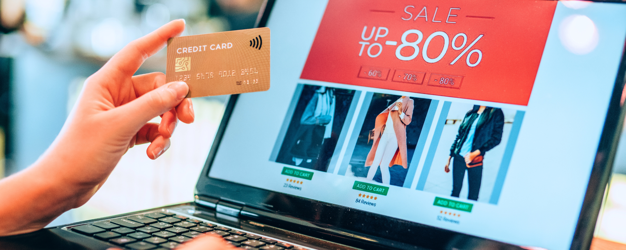 A person holding their credit card in front of their laptop screen showing a sale online - MAP Policies and Holiday Sales: The Discount Dilemma